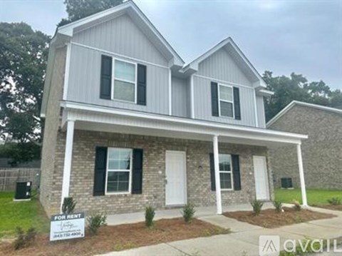 A two-story house with a white front porch is for rent.