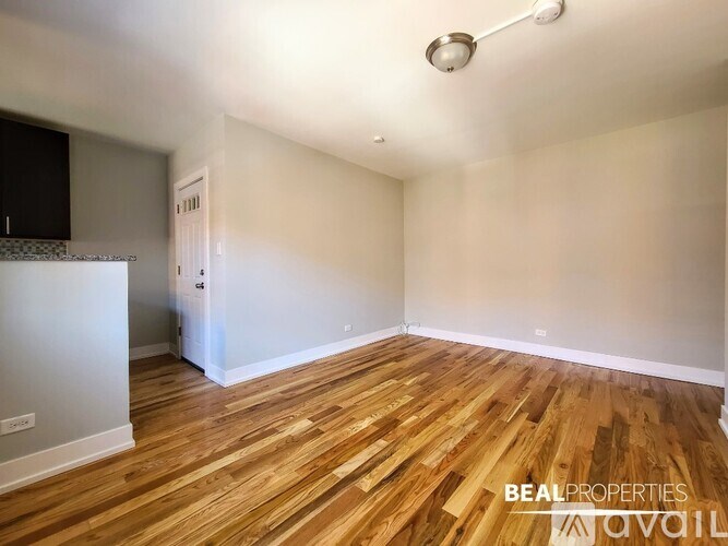 A room with wooden flooring and a white ceiling.