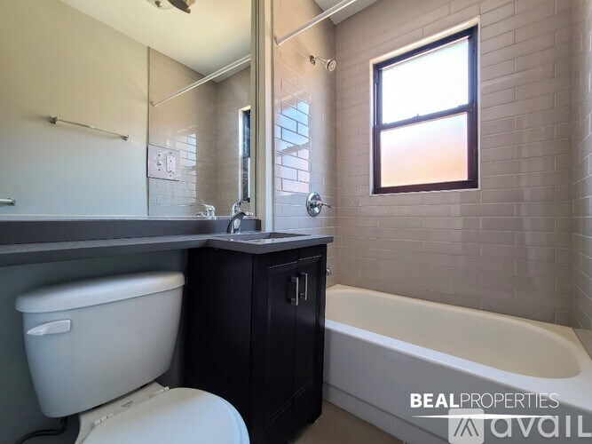 A bathroom with a toilet, sink, and bathtub.