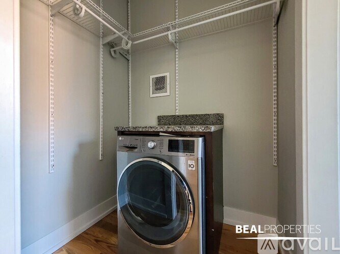 A washing machine is placed in a laundry room.