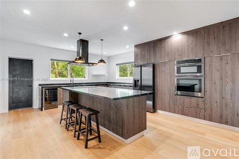 A modern kitchen with wooden cabinets and a central island.