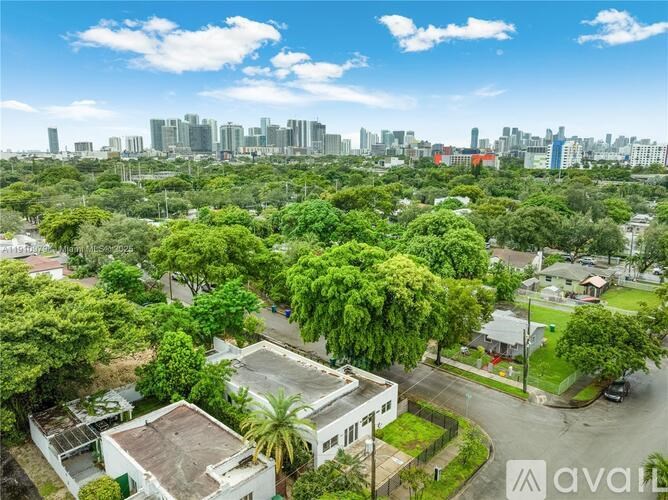 A bird's eye view of a residential area with houses and trees.