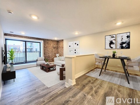 A living room with a brick wall and a balcony overlooking a cityscape.