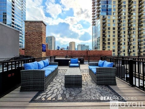 A patio with blue cushions and a brick wall in the background.