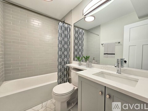 A bathroom with a toilet, sink, and bathtub.