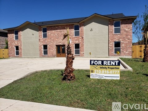 A house with a for rent sign in front of it.