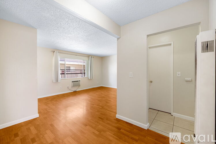 A room with wooden floors and white walls.
