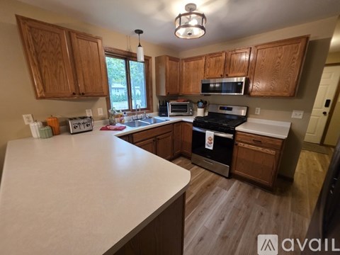 A kitchen with wooden cabinets and a white countertop.