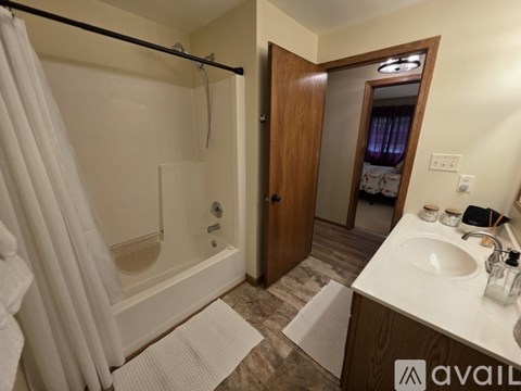 A bathroom with a white tub and a white sink.
