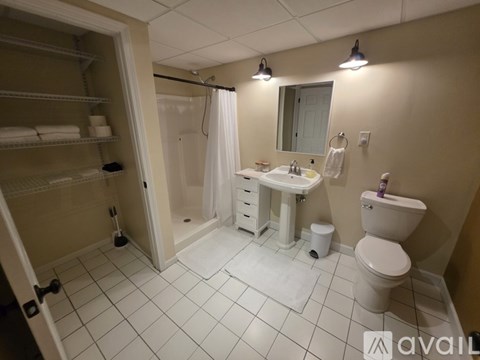 A bathroom with a toilet, sink, and shower.