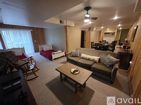 A living room with a couch, chairs, and a coffee table.