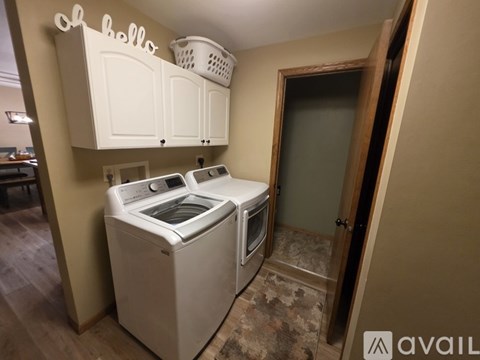 A white washing machine and dryer in a laundry room.
