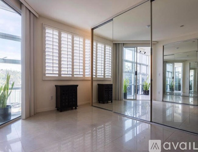 A spacious room with a fireplace and large windows.