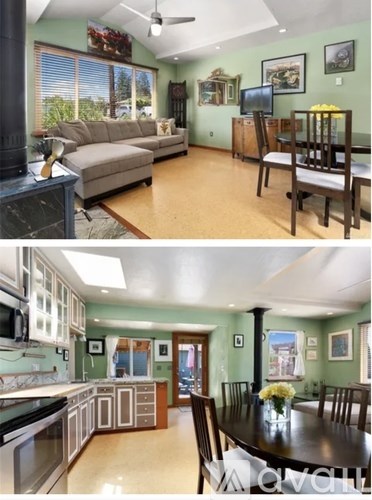 A living room with a couch and a dining table.