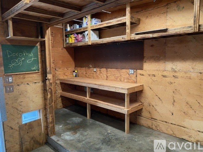 A room with wooden walls and a chalkboard with the name "Dorothy" written on it.