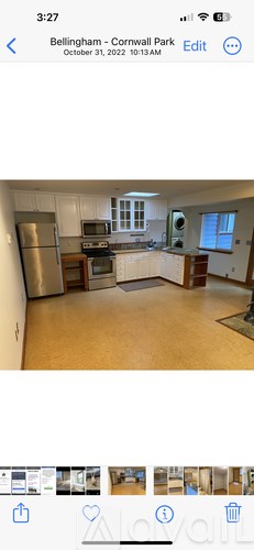 A kitchen with a refrigerator, oven, and sink.