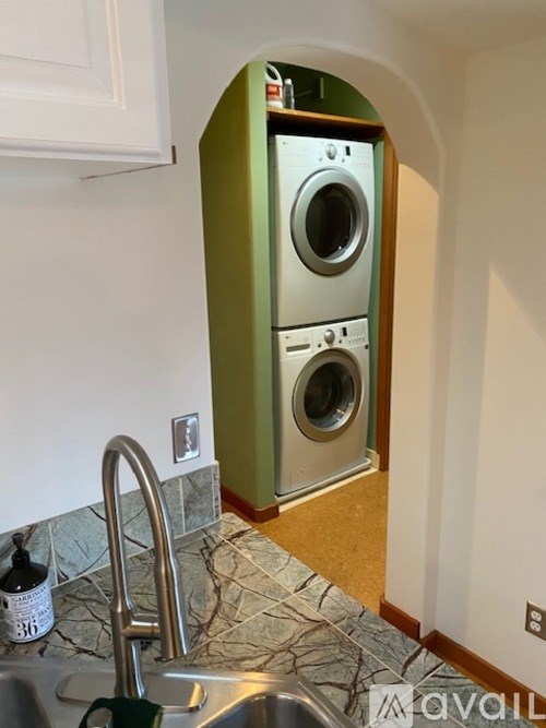 A kitchen with a green washer and dryer in it.