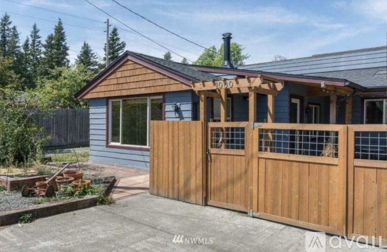 A house with a brown wooden fence and a blue wall.