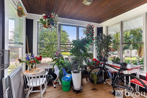 A room with a wooden ceiling and a bicycle leaning against the wall.