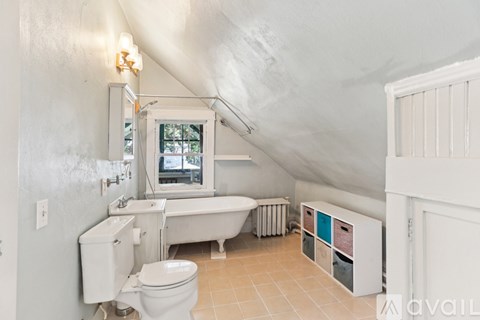 A bathroom with a toilet, sink, and bathtub.