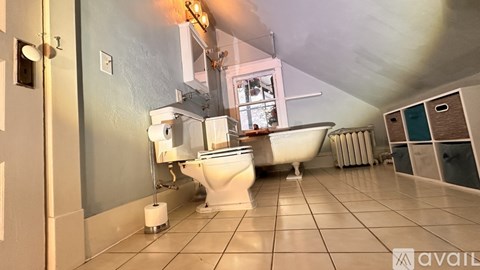 A bathroom with a toilet, sink, and bathtub.