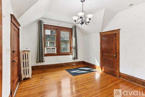 A room with wooden floors and a chandelier.
