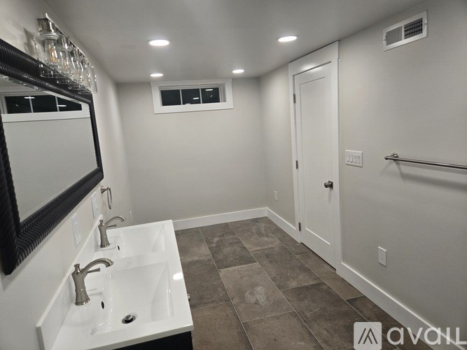 A bathroom with a white sink and a mirror above it.
