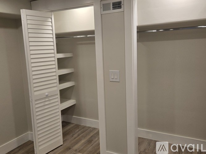 A white closet with a sliding door and shelves.