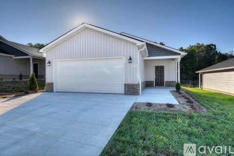 A house with a white garage door is for sale.