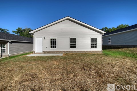 A house with a white door and windows is available for purchase.