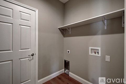 A white door is on the left and a coat rack is on the right.