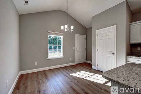 A room with wooden floors and a large window.