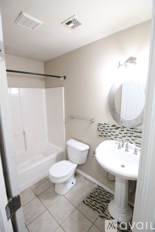 A white toilet and sink in a bathroom.
