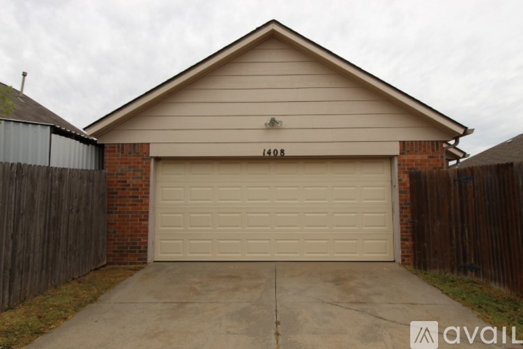 A house with a garage door and the number 1408 on it.