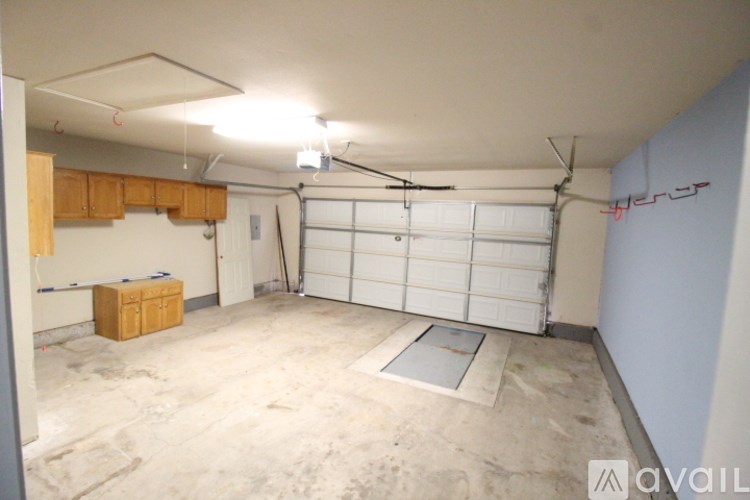 A garage with a white door and a brown box on the floor.
