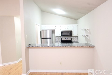 A kitchen with a microwave and oven built into a counter.