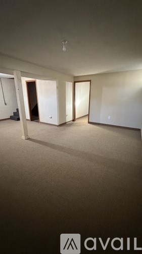 A room with a carpeted floor and a white ceiling with a light fixture.