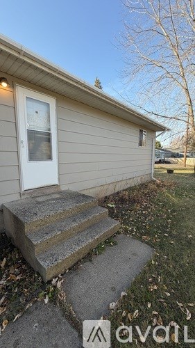 A house with a white door and a small porch.