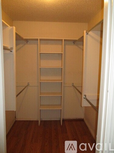 A small closet with a ladder and shelves.