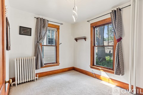 A room with a window and a radiator.