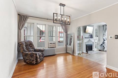 A living room with a chair and a fireplace.
