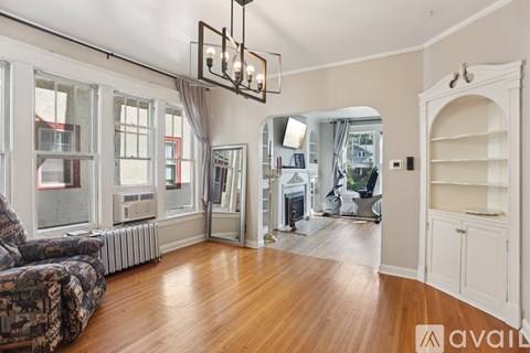 A living room with a couch and a chandelier.