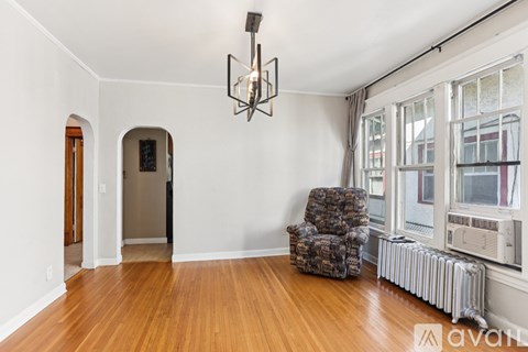 A room with a wooden floor and a chair.