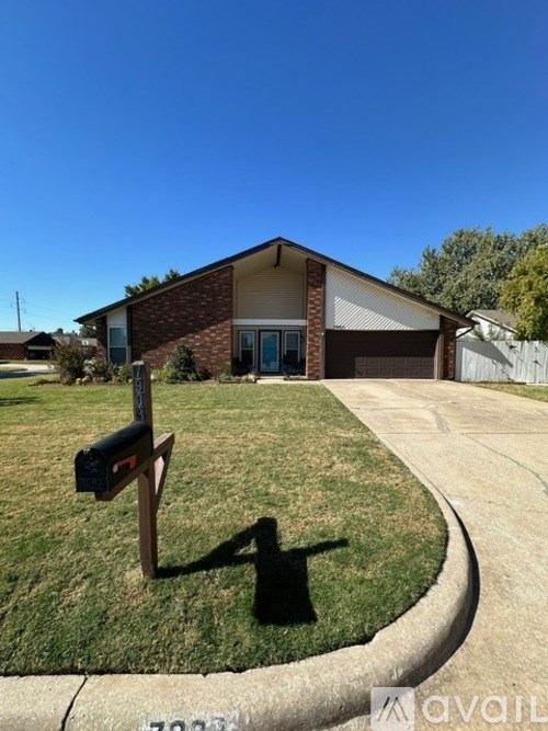 A house with a mailbox on the lawn.