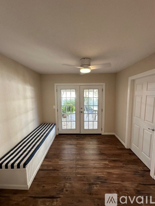 A room with a bench and a door leading outside.