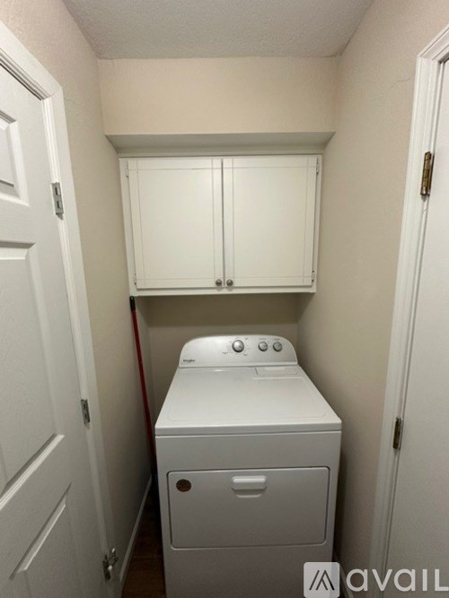 A small laundry room with a washer and dryer.