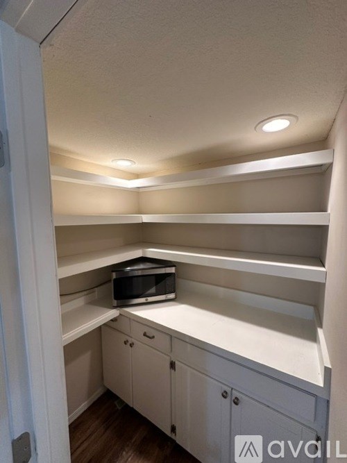 A small kitchen with a microwave on the counter.