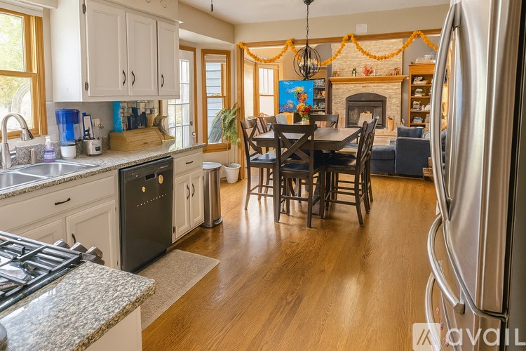 A kitchen with a dining table and chairs.