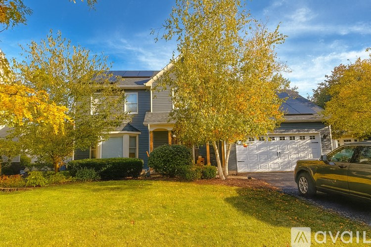 A house with a car parked in front of it.