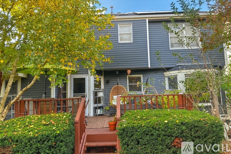 A house with a blue exterior and a red deck.